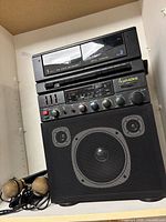 Full view of karaoke machine stacked with speaker and microphones