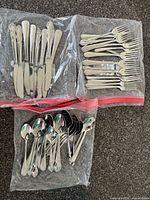All sealed bags of assorted flatware pieces