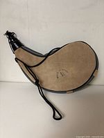 Full view of tan suede leather bota canteen with cord and cap