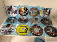 12 DVD discs in sleeves including Tupac Resurrection, Troy, Big Bounce, Crash, I, Robot, Bowling for Columbine and more