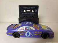 Front view of purple Grimace Go-Car with cassette standing behind