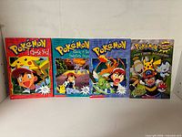 Group shot of all four Pokémon Scholastic paperbacks standing side-by-side