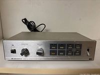 Front and top view of Archer switcher showing overall design and controls, attached cord visible