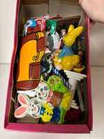 Shoebox filled with assorted vintage cake toppers and candles