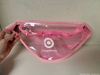 Front view showing clear body, logo, zipper and strap