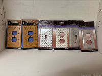 All six packaged wall plates arranged