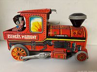 Left side view of locomotive showing graphics, driver figure, missing side part