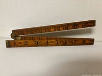 Meter stick folded showing graduations and brand area