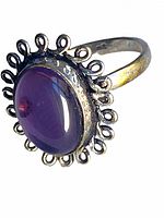 Side view showing amethyst cabochon and looped halo detail