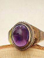 Close-up of the amethyst cabochon and rope bezel