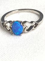 Ring angled to show opal, heart shoulders and 925 hallmark