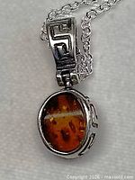 Front view of sterling silver Baltic amber pendant on chain