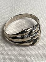 Top view of sterling silver ring showing dolphin motif