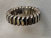 Close-up of the sterling silver band ring showing segmented design