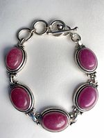 Full view of bracelet showing five ruby cabochons and toggle clasp
