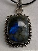 Front view of labradorite pendant in sterling bezel on cord