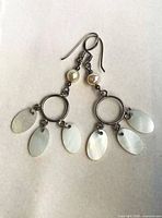 Front view showing both earrings with hooks, rings, pearl beads and mother of pearl drops