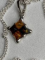 Close-up of amber pendant on chain