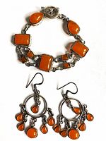 Bracelet and earrings laid flat showing overall design and cabochon shapes