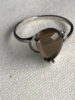 Overall view of sterling silver ring with pear smoky quartz cabochon