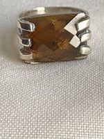 Front view of sterling silver ring displaying the faceted smoky quartz stone