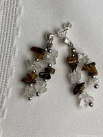 Full view of both dangle earrings