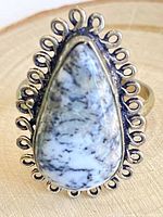 Front view showing tree agate stone and ornate silver border