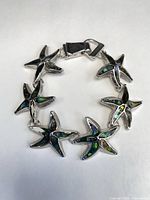 Full view of starfish bracelet showing abalone inlay and links