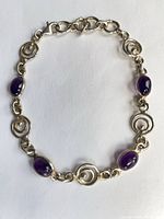 Full view of bracelet showing stones and swirl links