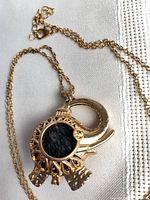 Pendant front showing elephant shape and lava stone