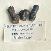 Label with three hematite after malachite stones
