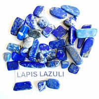 Spread of blue lapis lazuli stones on white background