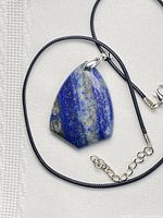 Front view of lapis lazuli shield pendant on black cord