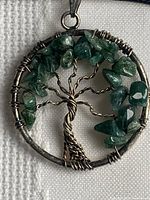 Close-up of pendant front showing malachite chips and wire detail