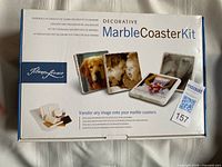 Front of box showing product name and images of finished coasters