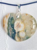 Front view of heart-shaped ocean jasper pendant on cord