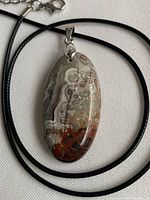 front view of agate pendant on black cord