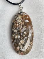 Front view of ocean jasper pendant showing pattern and silver bail