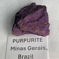 Front view of purpurite specimen showing vibrant purple coloration on matrix.
