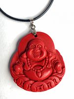 Front view of red cinnabar Laughing Buddha pendant on cord