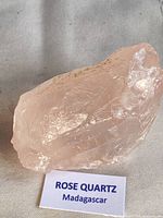 rose quartz specimen on fabric surface with label