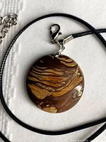 Front of round jasper pendant on cord