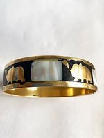 Side view showing mother of pearl panel and brass elephant inlay