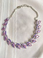 Front view of entire necklace showing tulip motif and chain