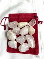 Tumbled quartz stones on red velvet pouch