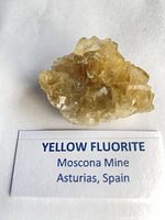 Yellow fluorite specimen with label identifying origin