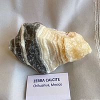 Front view showing layered black, white and beige bands