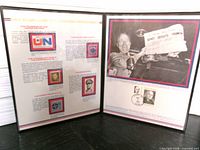 Open folio showing mounted stamps and informational text