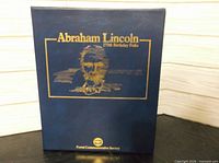 Front of navy blue folio with gold title text