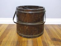 Full view of wooden bucket front with handle down